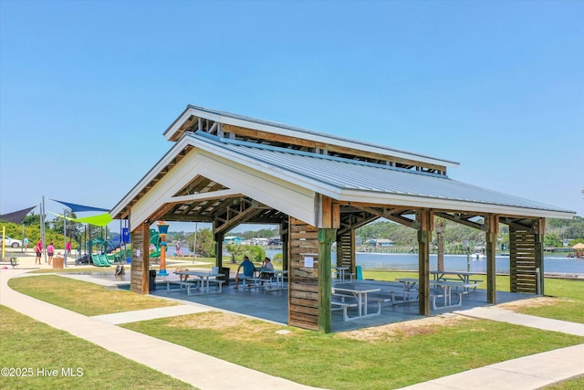 surrounding community featuring a gazebo, a lawn, a playground, and a water view