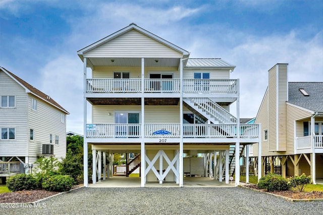 raised beach house featuring a carport