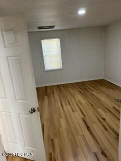 empty room with hardwood / wood-style flooring