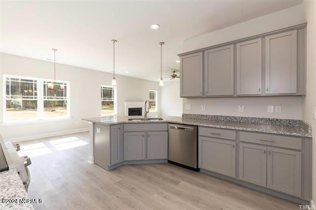 kitchen featuring sink, gray cabinetry, hanging light fixtures, stainless steel dishwasher, and kitchen peninsula