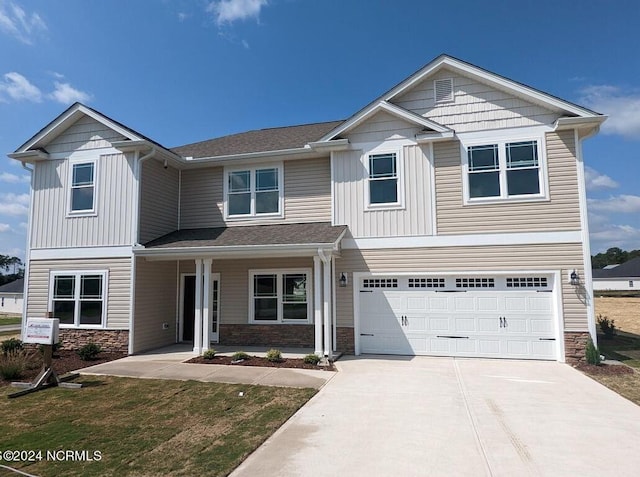 view of front of property featuring a garage and a porch