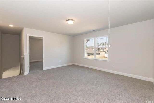 empty room with carpet flooring