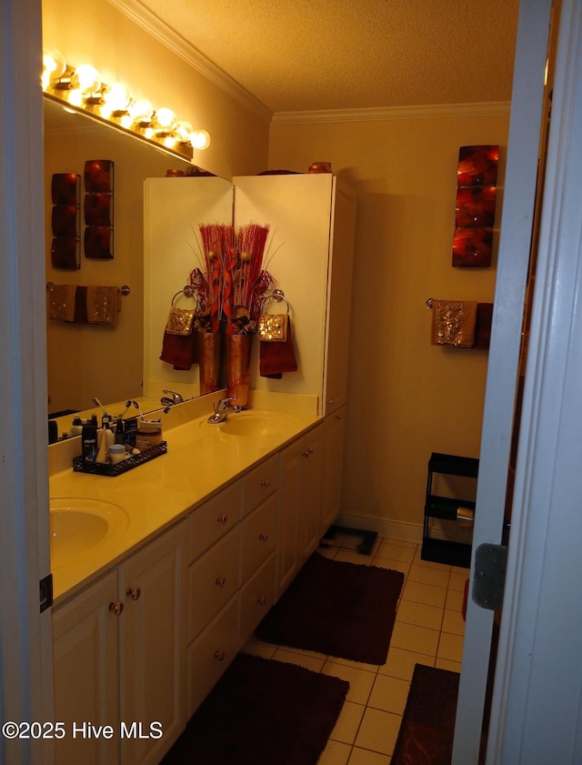 bathroom with a sink, tile patterned flooring, a textured ceiling, and ornamental molding