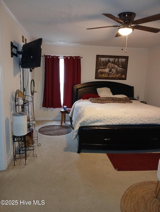carpeted bedroom featuring a ceiling fan, baseboards, and ornamental molding