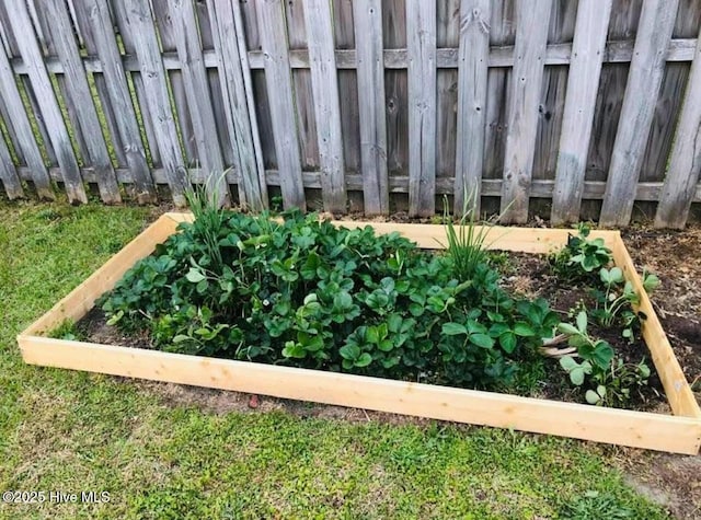 exterior details featuring a vegetable garden and fence