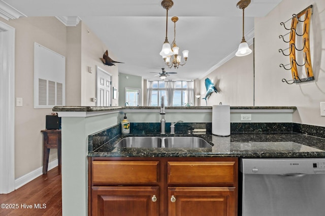 kitchen with decorative light fixtures, dishwasher, sink, dark stone countertops, and dark wood-type flooring