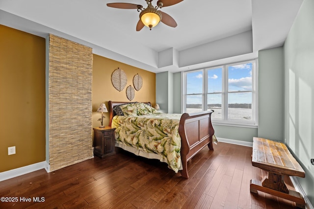 bedroom with dark hardwood / wood-style floors and ceiling fan