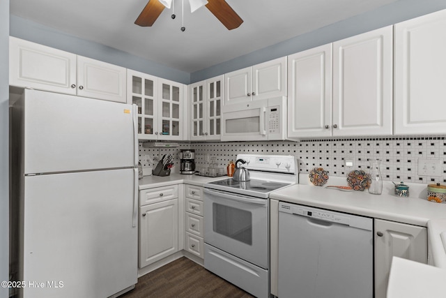 kitchen with white cabinetry, white appliances, dark hardwood / wood-style flooring, and decorative backsplash