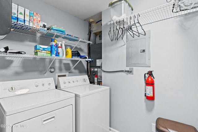 laundry area featuring washing machine and clothes dryer and electric panel