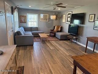 living room with ceiling fan and hardwood / wood-style floors