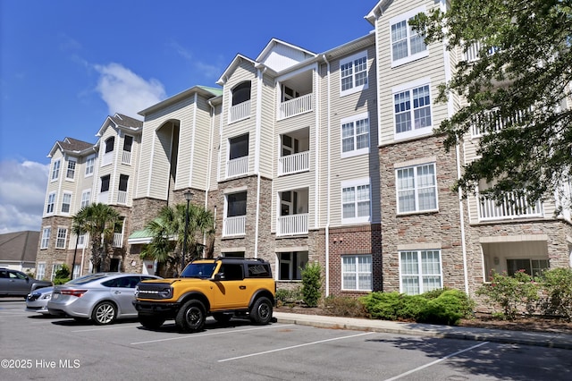 view of building exterior featuring uncovered parking