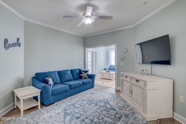 living area with ornamental molding and wood finished floors