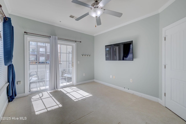 empty room featuring ornamental molding, carpet, and baseboards