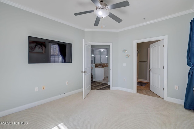 unfurnished bedroom with baseboards, carpet, ornamental molding, and connected bathroom