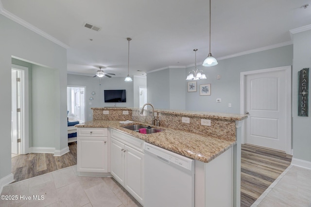 kitchen with light stone counters, visible vents, open floor plan, white dishwasher, and a sink