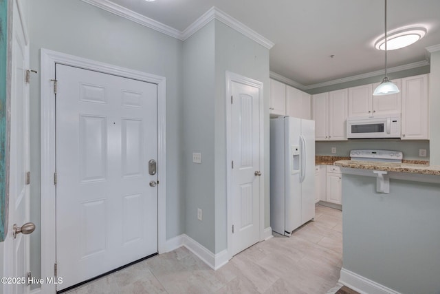 kitchen featuring white appliances, white cabinetry, crown molding, and decorative light fixtures