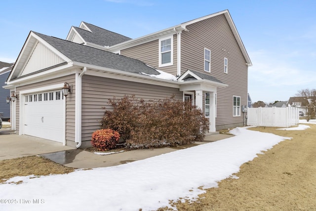 view of snow covered exterior with a garage