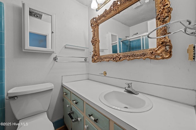 bathroom with vanity, toilet, and an enclosed shower