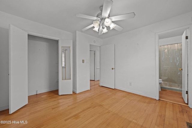 unfurnished bedroom with ensuite bath, light hardwood / wood-style floors, and ceiling fan