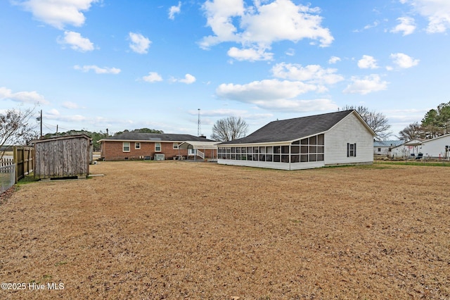 view of yard with a storage unit and a sunroom