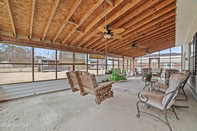 unfurnished sunroom featuring ceiling fan