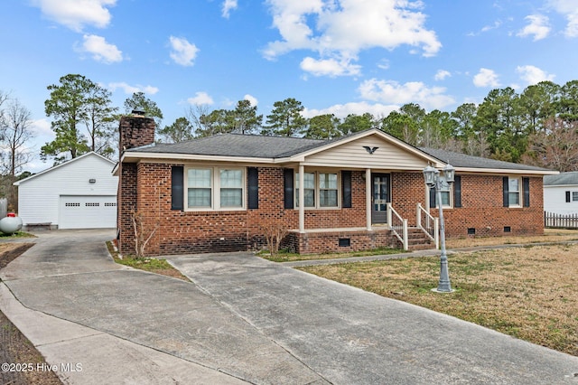 ranch-style house featuring an outbuilding, a garage, and a front yard