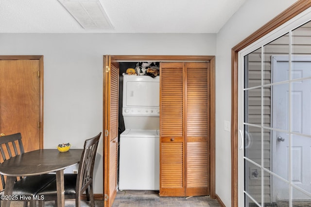 laundry area with stacked washer and dryer