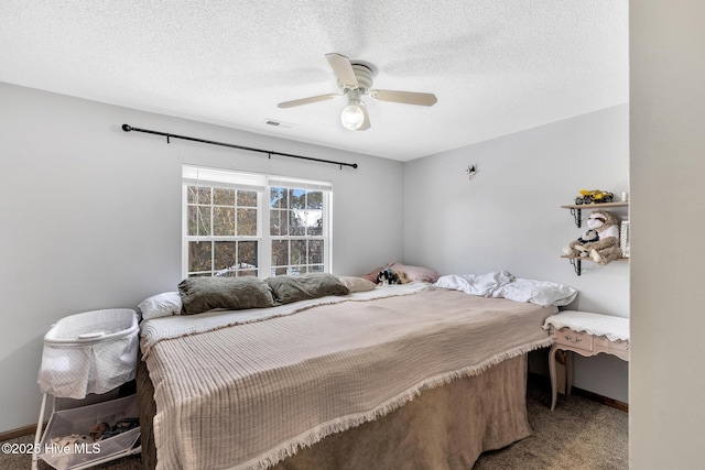 carpeted bedroom with a textured ceiling and ceiling fan