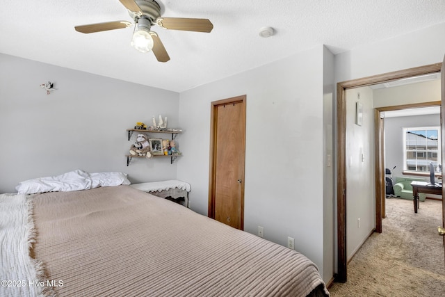 bedroom featuring light colored carpet and ceiling fan