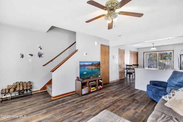 living room with ceiling fan and dark hardwood / wood-style flooring