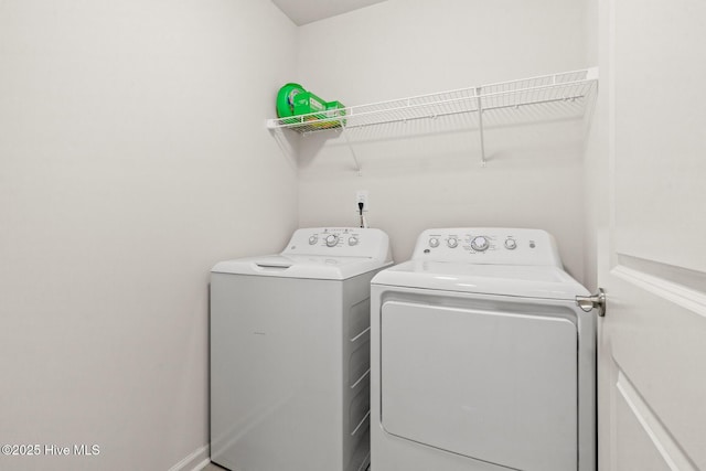 clothes washing area with washing machine and dryer