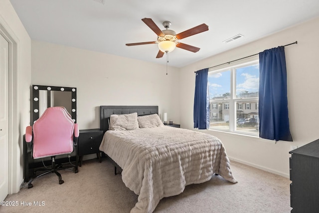 bedroom featuring light carpet and ceiling fan