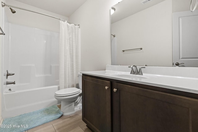 full bathroom with vanity, shower / tub combo, and toilet