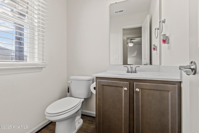 bathroom with hardwood / wood-style flooring, vanity, and toilet