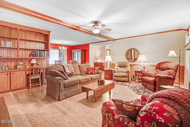 living room featuring crown molding, ceiling fan with notable chandelier, and light hardwood / wood-style floors