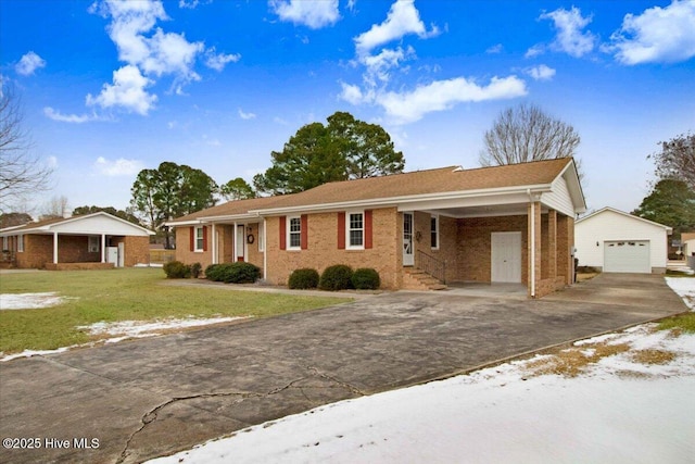 ranch-style house with an outbuilding, a garage, a front lawn, and a carport