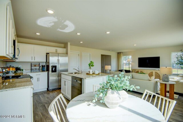 dining room featuring wood finished floors and recessed lighting