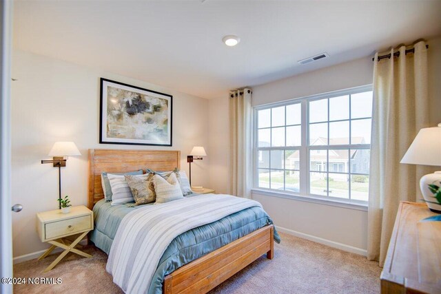 bedroom featuring carpet flooring, visible vents, and baseboards