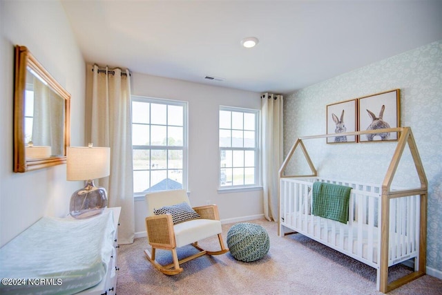 bedroom with carpet floors, visible vents, baseboards, and wallpapered walls