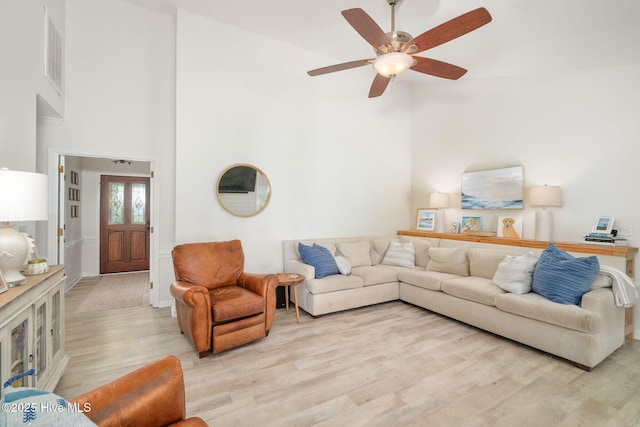 living room featuring ceiling fan and light hardwood / wood-style floors