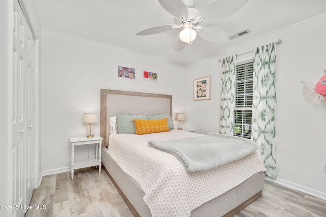 bedroom with ceiling fan, hardwood / wood-style floors, and a closet