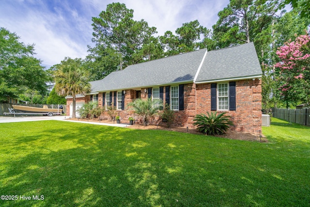 ranch-style house featuring cooling unit, a garage, and a front lawn