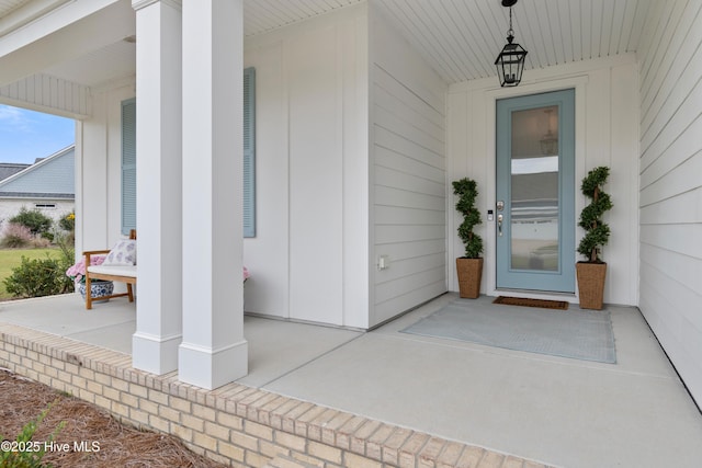 view of exterior entry with covered porch