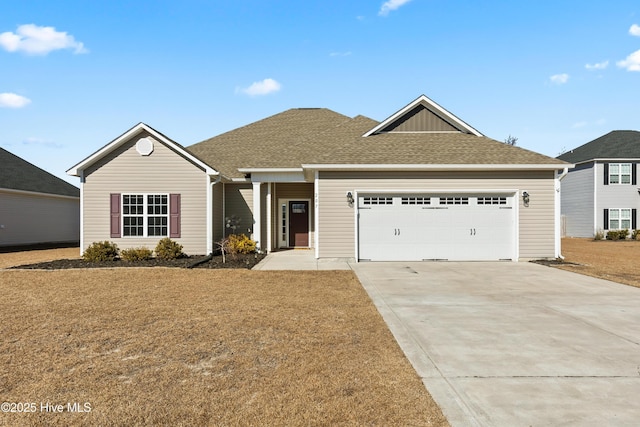 view of front of property featuring a garage and a front lawn