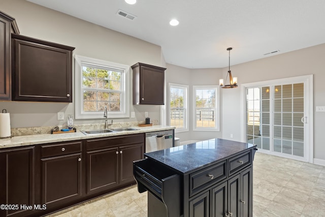 kitchen with sink, hanging light fixtures, a center island, light stone counters, and stainless steel dishwasher