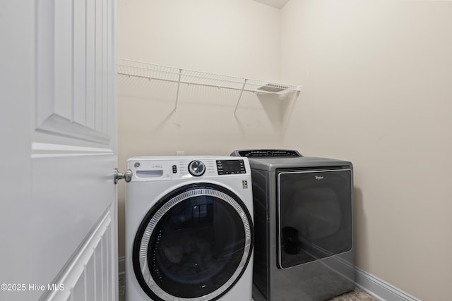 clothes washing area featuring separate washer and dryer