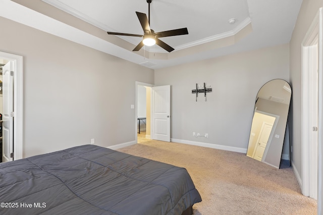 carpeted bedroom featuring crown molding, a raised ceiling, and ceiling fan