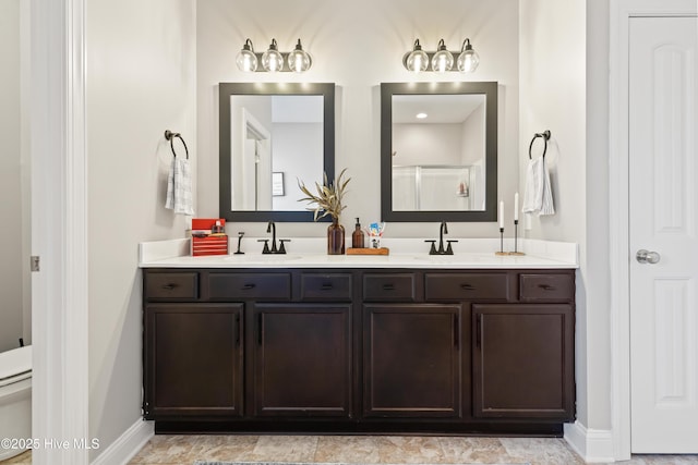 bathroom featuring an enclosed shower, vanity, and toilet