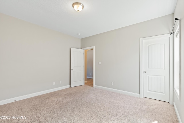 unfurnished bedroom featuring light colored carpet