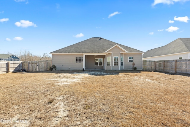 back of property featuring a yard